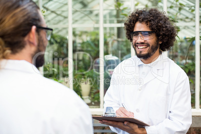 Male scientists smiling while discussing