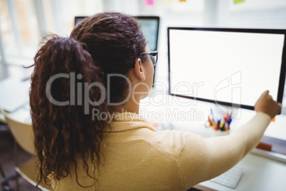 Rear view of businesswoman working in office