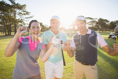 Portrait of cheerful golfer friends