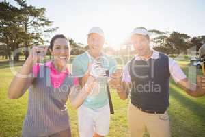 Portrait of cheerful golfer friends