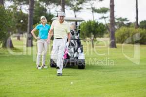 Couple standing at golf course