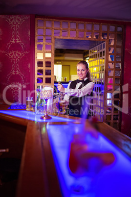 Bartender pouring beer in glass