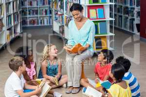 Teacher with students reading books