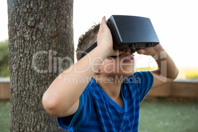 Boy using virtual reality headset at park