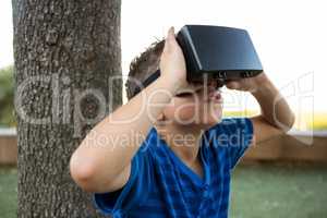 Boy using virtual reality headset at park