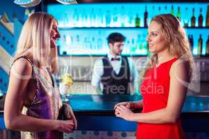 Female friends talking at bar counter