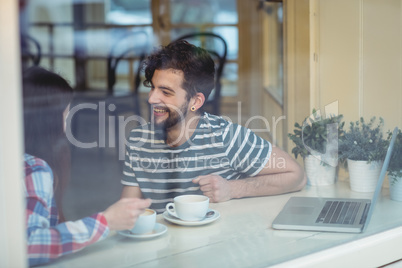 Happy couple talking at coffee shop