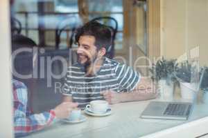 Happy couple talking at coffee shop