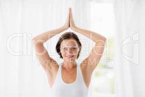 Portrait of smiling woman doing yoga