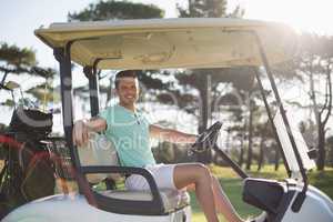 Portrait of smart man sitting in golf buggy