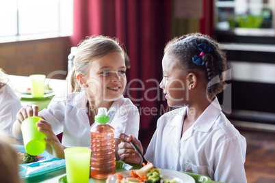 Girls having food in canteen