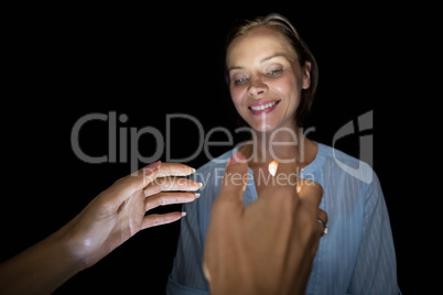 Cropped image of hypnotist hypnotizing woman