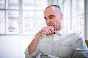 Thoughtful businessman with hand on chin