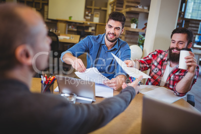 Business people giving documents to colleague