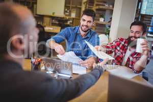 Business people giving documents to colleague