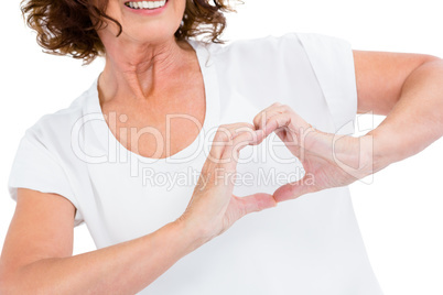 Cropped image of woman making heart shape with hands