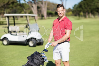 Portrait of smiling man holding golf club