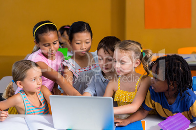 Classmates using laptop