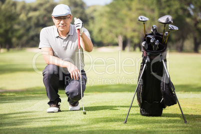 Golfer crouching and posing