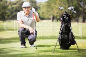 Golfer crouching and posing