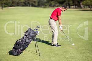 Full length side view of man playing golf