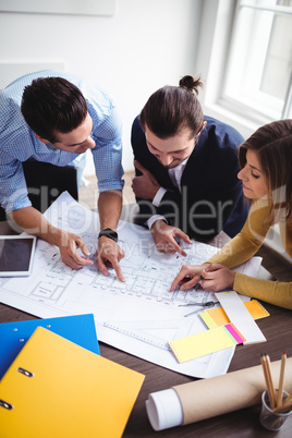 Business people discussing on blueprint