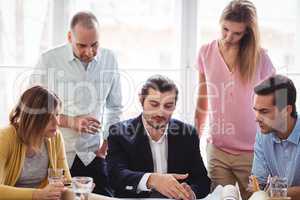 Businessman discussing with coworkers