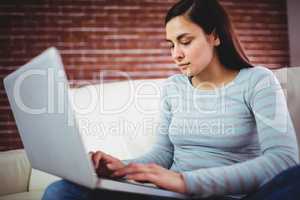 Beautiful woman using laptop at home