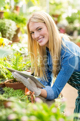 Female gardener using tablet computer