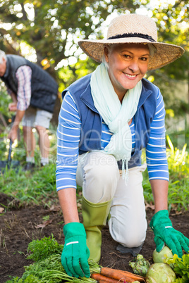 Portrait of happy gardener with colleague working at garden