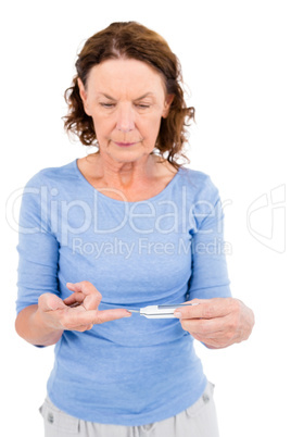 Mature woman using blood glucose monitor