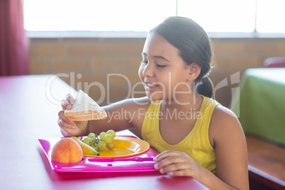 Schoolgirl having meal