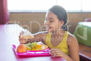 Schoolgirl having meal