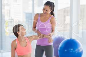 Happy fitness instructor with woman