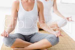 Women in lotus position doing yoga