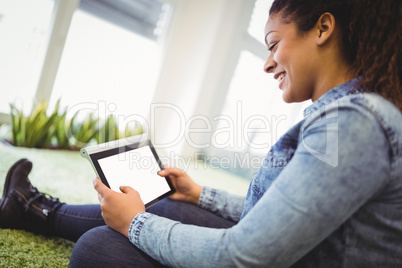 Businesswoman using digital tablet in creative office