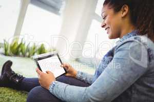 Businesswoman using digital tablet in creative office