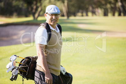 Sportsman posing with his golf bag