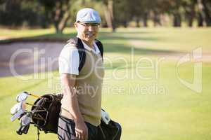 Sportsman posing with his golf bag