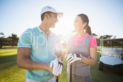 Cheerful golf player couple