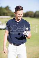 Cheerful young man with golf ball