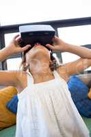Elementary girl looking through virtual reality headset in schoo