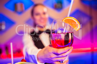 Barmaid holding cocktail glass