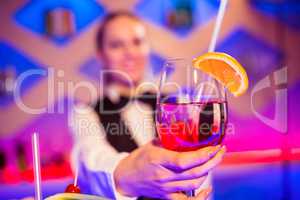 Barmaid holding cocktail glass