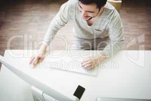 High angle view of businessman working on computer