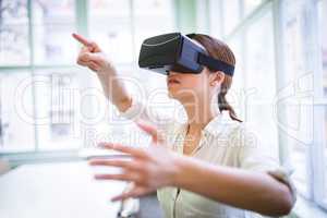Graphic designer gesturing while using virtual reality headset
