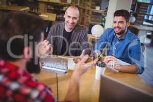 Business people smiling discussing at desk