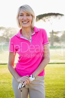 Portrait of woman golfer smiling and posing