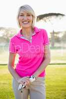 Portrait of woman golfer smiling and posing