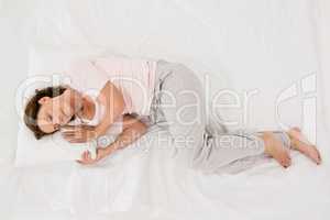 Full length of mature woman sleeping on bed